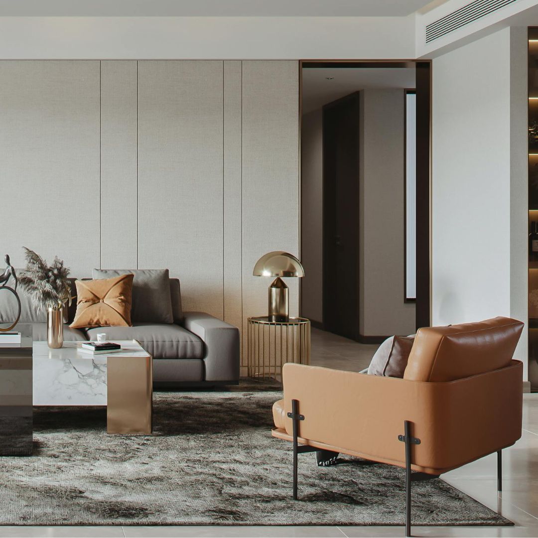 A modern living room with a gray sofa, tan armchair, glass-top coffee table, and a decorative lamp on a side table. The space exudes elegance with high-end area rugs such as Duralux™ Comfort 7 mm by Dura Undercushions, enhancing the neutral tones and minimalist design.