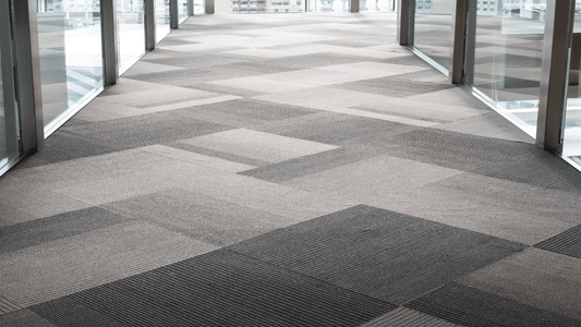 Modern office space with carpet tiles and acoustic underlay for flooring comfort and noise reduction.